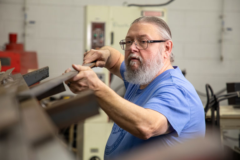 person working with metal