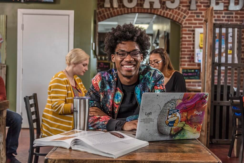 guy at table with laptop