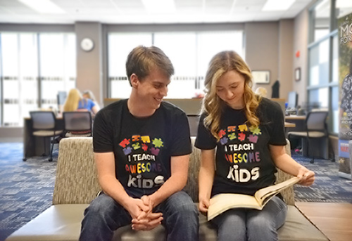 Two Students Sitting and Reading